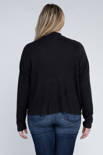 Plus size model wearing Raya Curvy Plus Drop Shoulder Top in black with mock neck, back view styled with jeans.