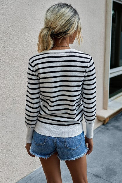 Beeba Stripe V Neck Sweater back view in white with black stripes and ribbed hem.