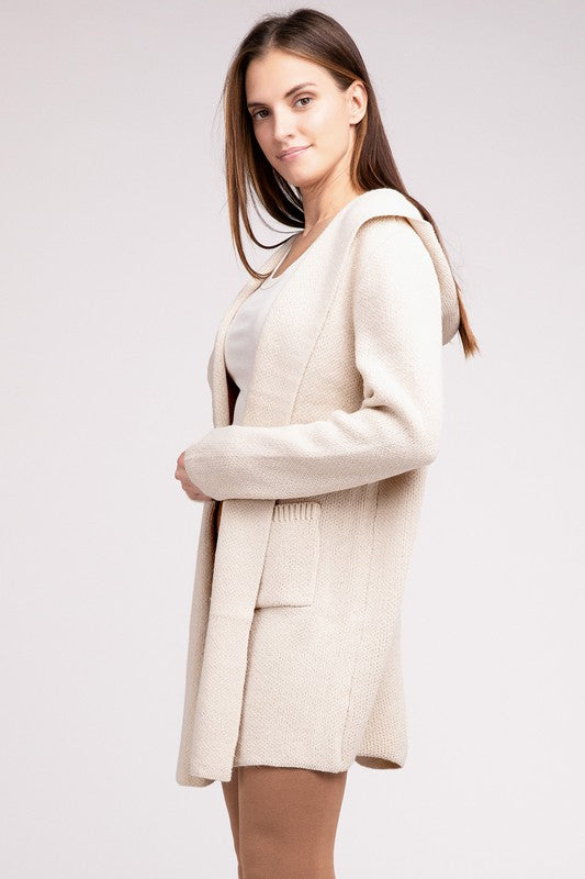 Sand Beige sweater cardigan with long sleeves, front pockets, and a hooded neckline. 