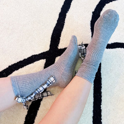 Woman wearing grey Plaid Ruffle Bow Socks showing soft knit and playful accents.