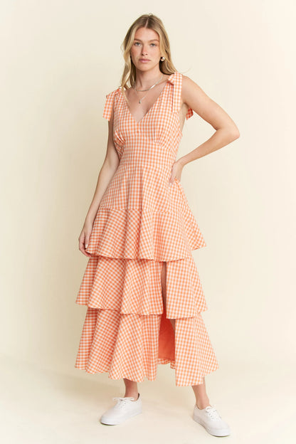 Front view of Alice Gingham Tiered Midi Dress by Jade by Jane, showing halter neckline, tiered ruffle layers, and cheerful orange gingham pattern.