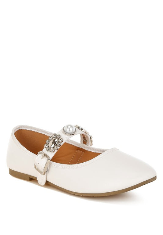 Front angle view of white Kavana Mary Jane Flats featuring pearl and rhinestone charm embellishments on vegan leather.