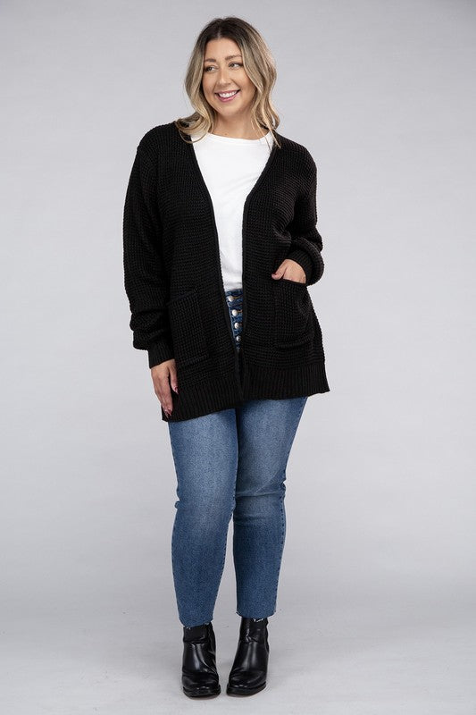 Curvy plus-size waffle-pattern open cardigan sweater in black, with long sleeves, oversized fit, and pockets.