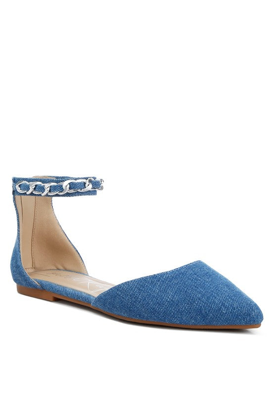 Denim flats with a pointed toe, chain ankle strap, and flat heel .