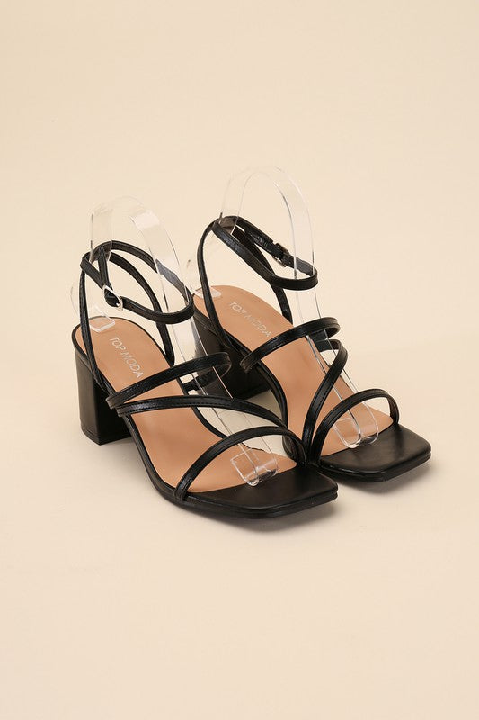 Black strappy sandals with a 2" low heel, ankle strap closure, and criss-cross embellishments.