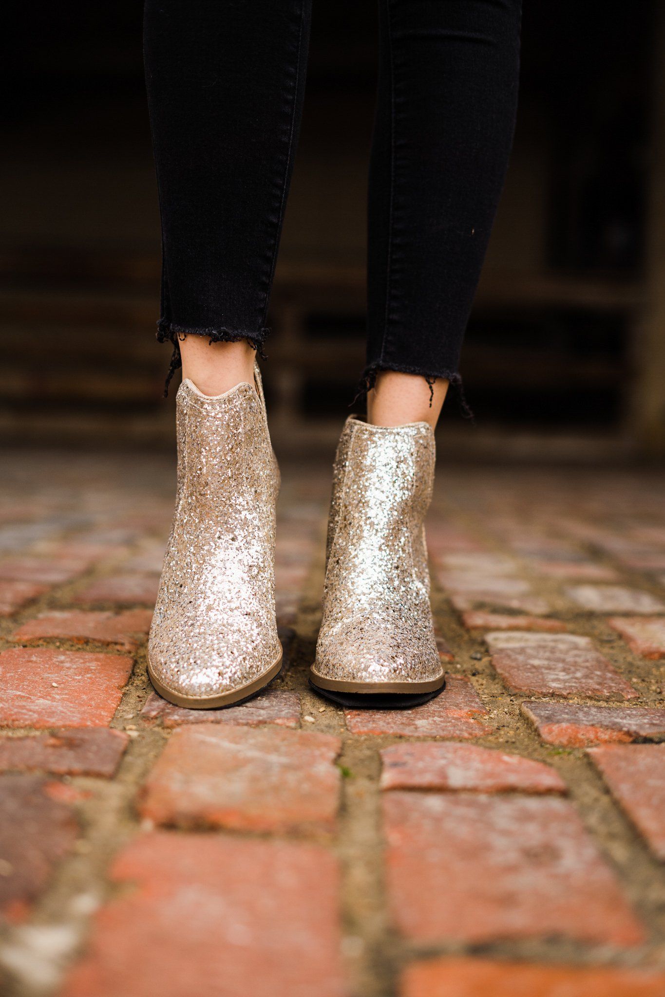 Gold glitter booties with a 3-inch heel, rubber soles, and a sparkling finish for a glamorous party look.