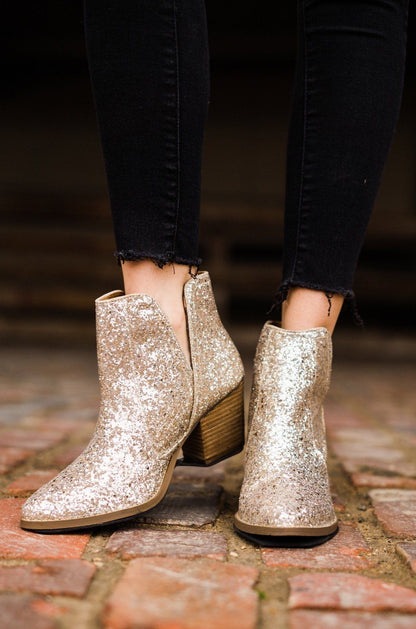 Gold glitter booties with a 3-inch heel, rubber soles, and a sparkling finish for a glamorous party look.
