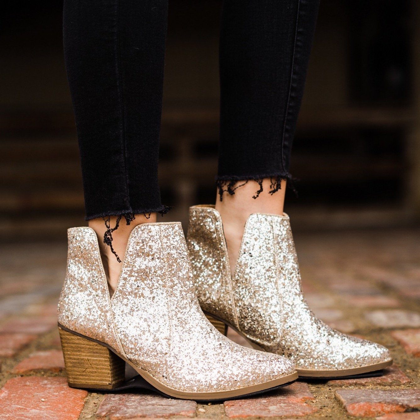 Gold glitter booties with a 3-inch heel, rubber soles, and a sparkling finish for a glamorous party look.