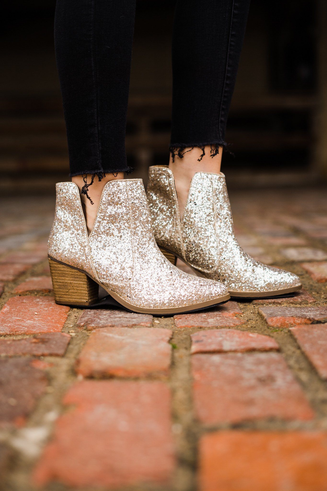 Gold glitter booties with a 3-inch heel, rubber soles, and a sparkling finish for a glamorous party look.