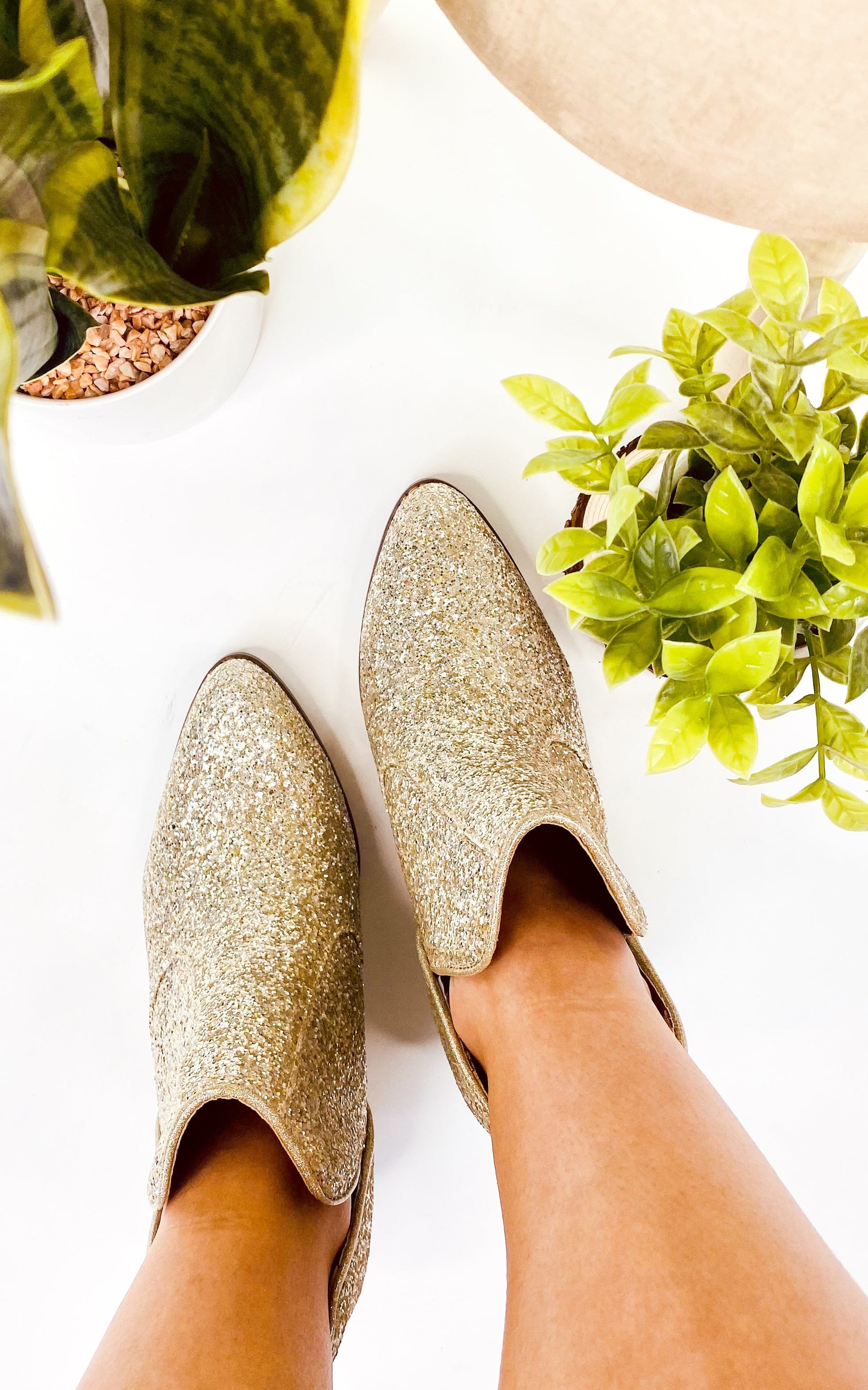 Gold glitter booties with a 3-inch heel, rubber soles, and a sparkling finish for a glamorous party look.