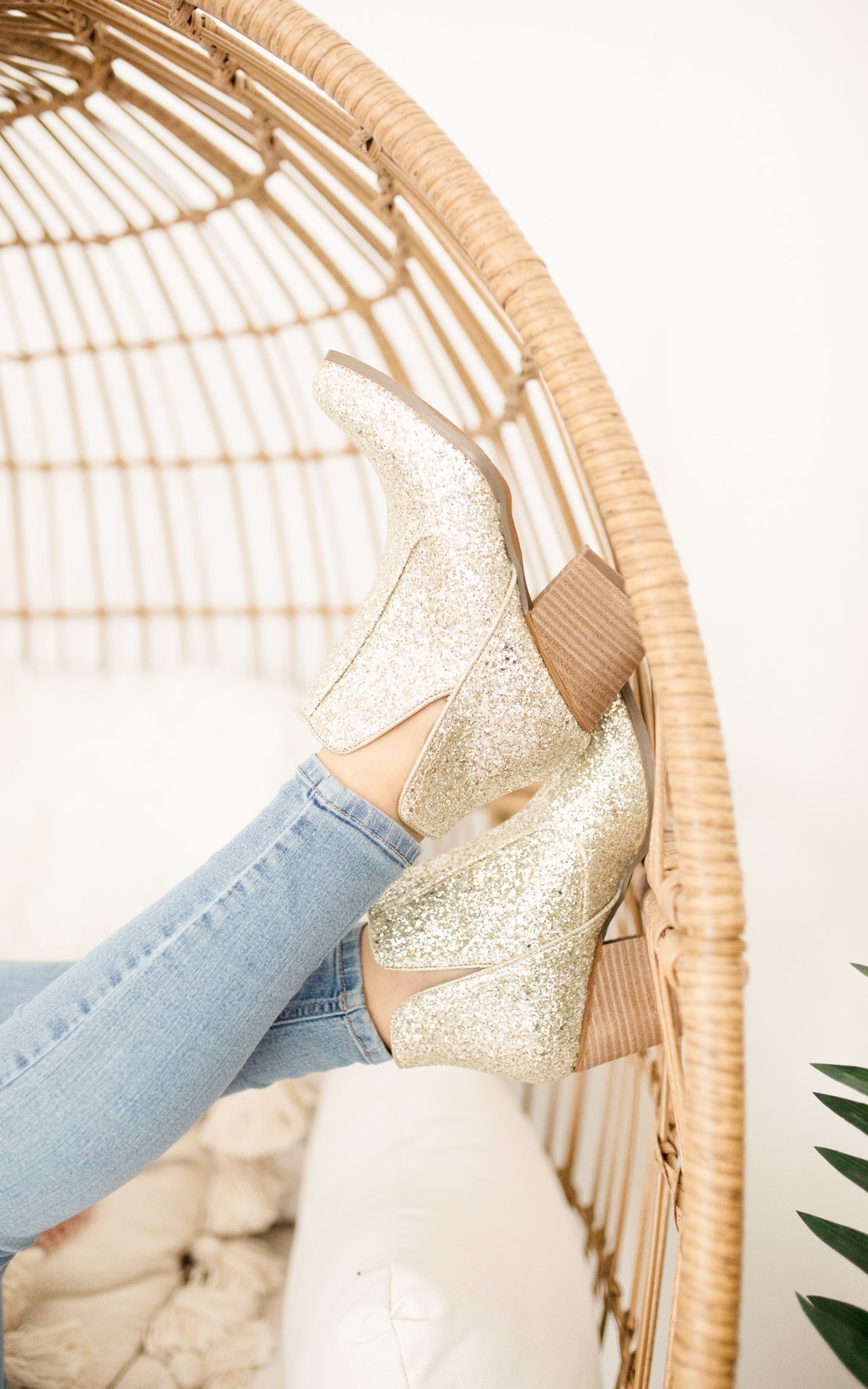 Gold glitter booties with a 3-inch heel, rubber soles, and a sparkling finish for a glamorous party look.