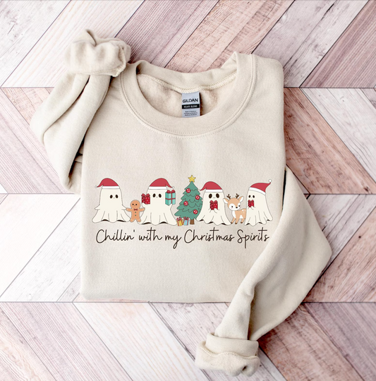 Festive sand-colored sweatshirt featuring playful ghosts in Santa hats around a Christmas tree with the text "Chillin' With My Christmas Spirits." 