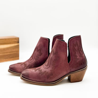 Burgandy leather booties with Western embroidery, roomy snip toe, cushioned footbed, and ankle slits.