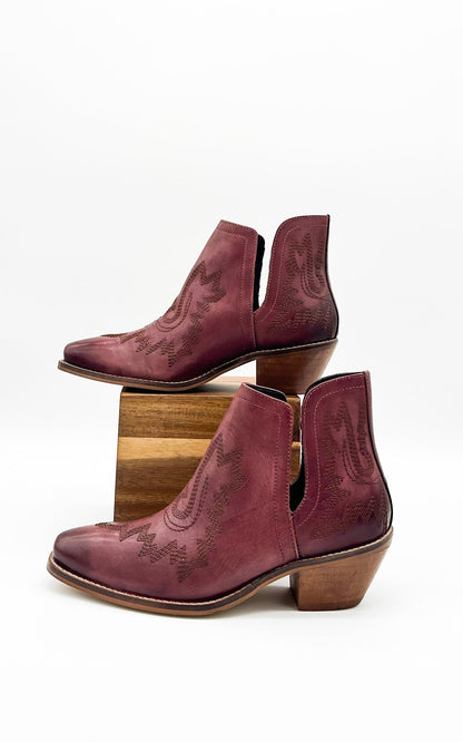 Burgandy leather booties with Western embroidery, roomy snip toe, cushioned footbed, and ankle slits.
