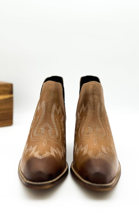 Tan leather booties with Western embroidery, roomy snip toe, cushioned footbed, and ankle slits.