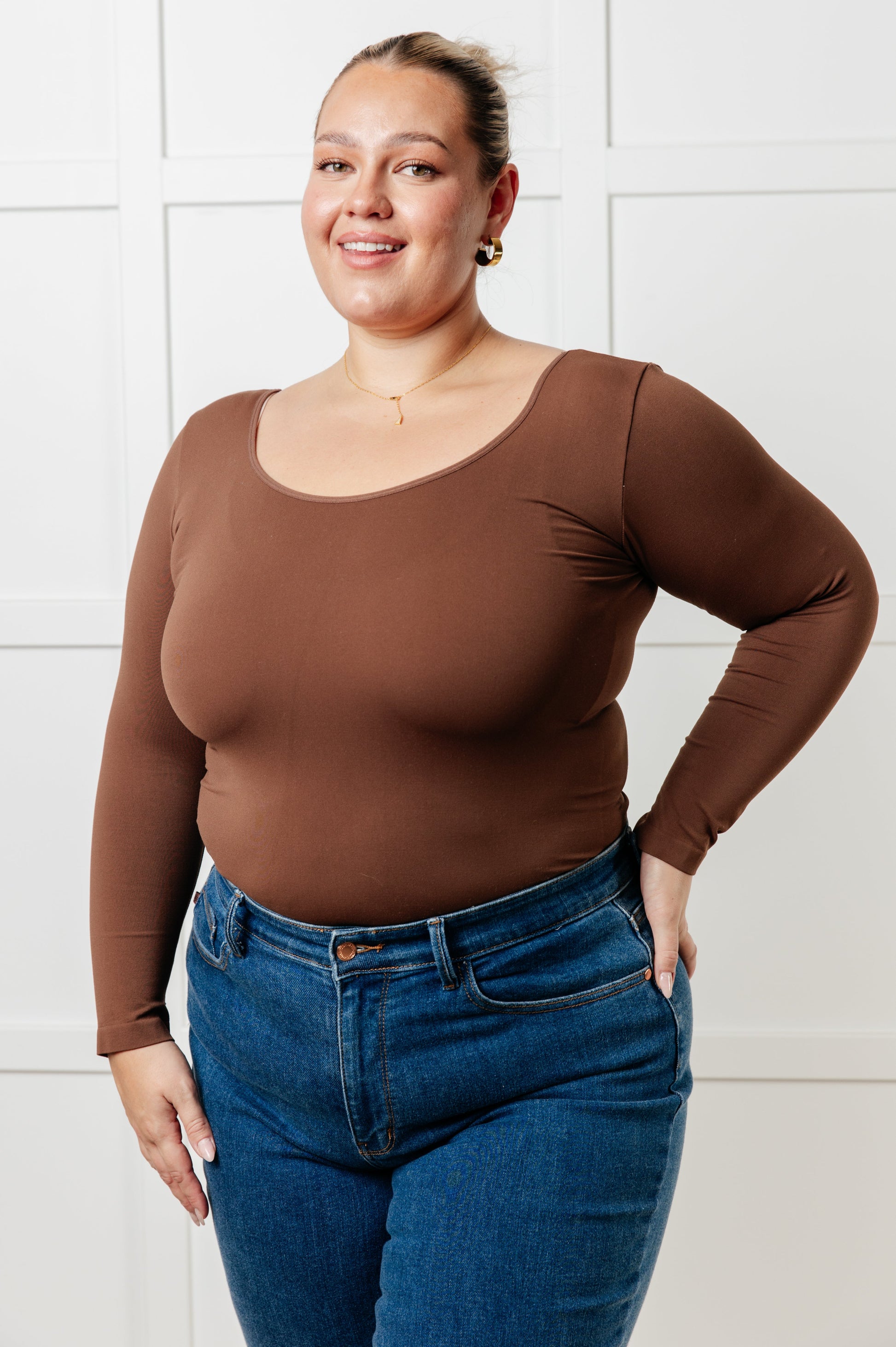 Coffee colored brushed microfiber reversible top with a scoop or V-neckline, long sleeves, and a form-fitting silhouette.