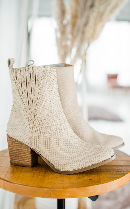 Women's cream ankle boots with a genuine leather upper, snakeskin leather detailing, inside zipper, cushioned footbed, and a 2.75-inch heel.