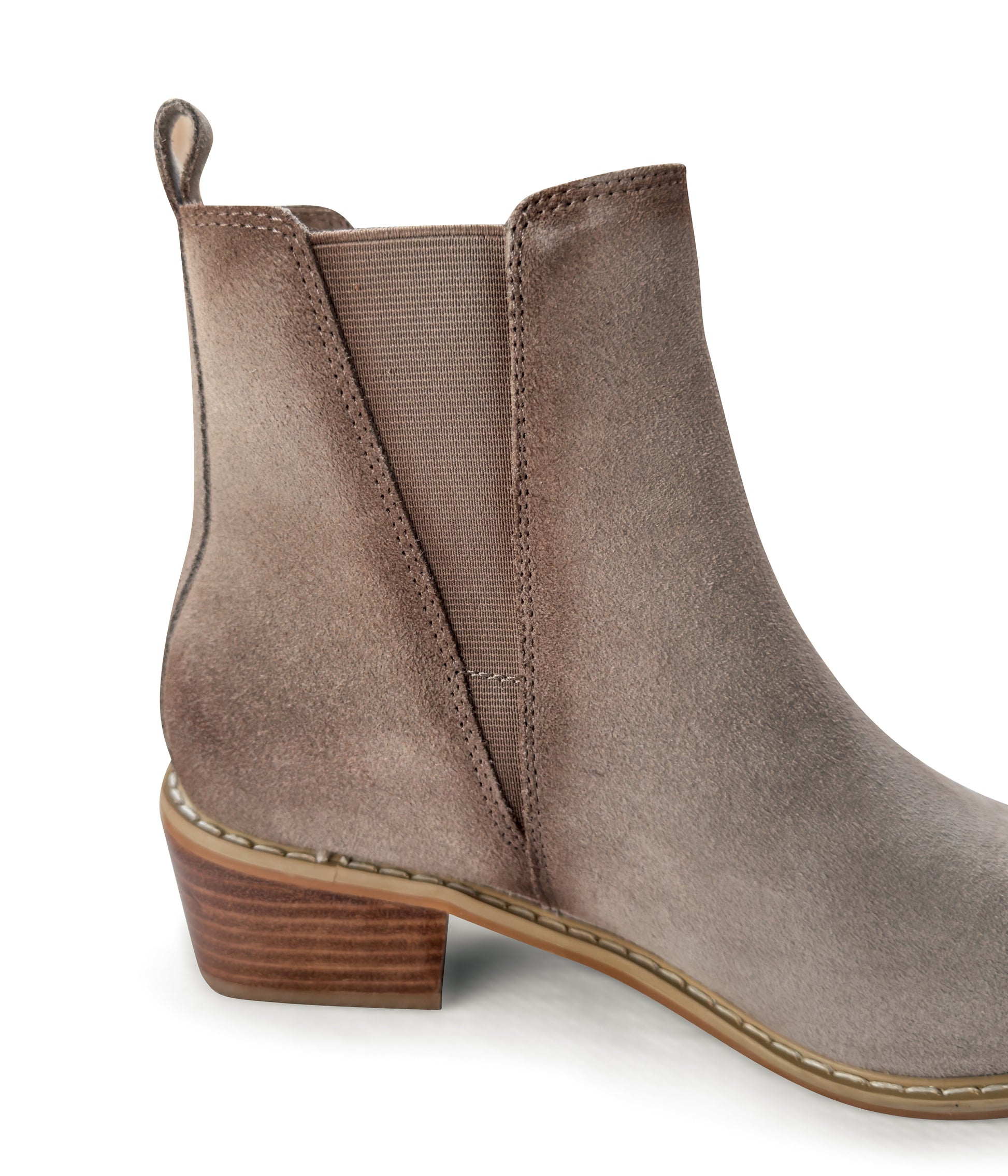 Women's taupe ankle booties made of genuine suede with a leather lining, featuring a slight pointed toe with a silver accent, 1.5-inch heel, pull-on style with elastic side panels and a pull tab. 