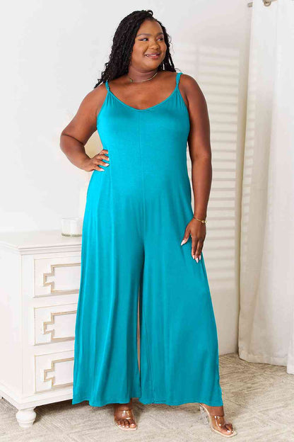 Plus size model in sky blue jumpsuit with flattering wide-leg fit and functional pockets.