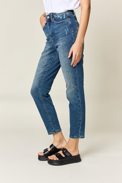 Judy Blue High Waist Slim Jeans in dark denim, featuring tummy control, a zip fly, and a flattering, highly stretchy fit. It has a slim, long leg and high waist.