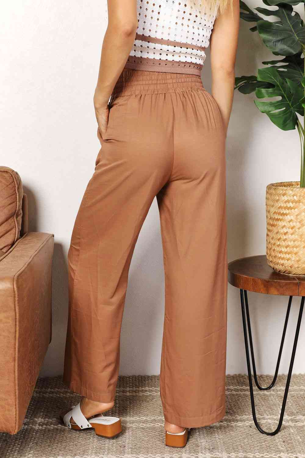 Camel colored, wide-leg pants with a drawstring-smocked waist.