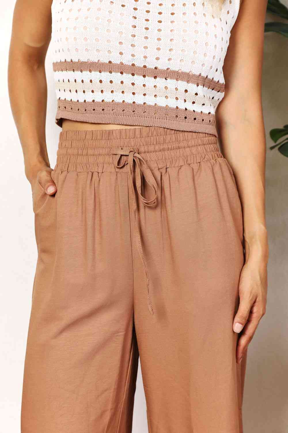 Camel colored, wide-leg pants with a drawstring-smocked waist.