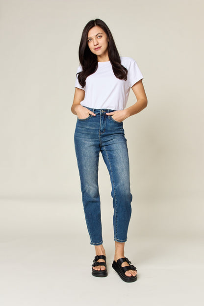 Judy Blue High Waist Slim Jeans in dark denim, featuring tummy control, a zip fly, and a flattering, highly stretchy fit. It has a slim, long leg and high waist.