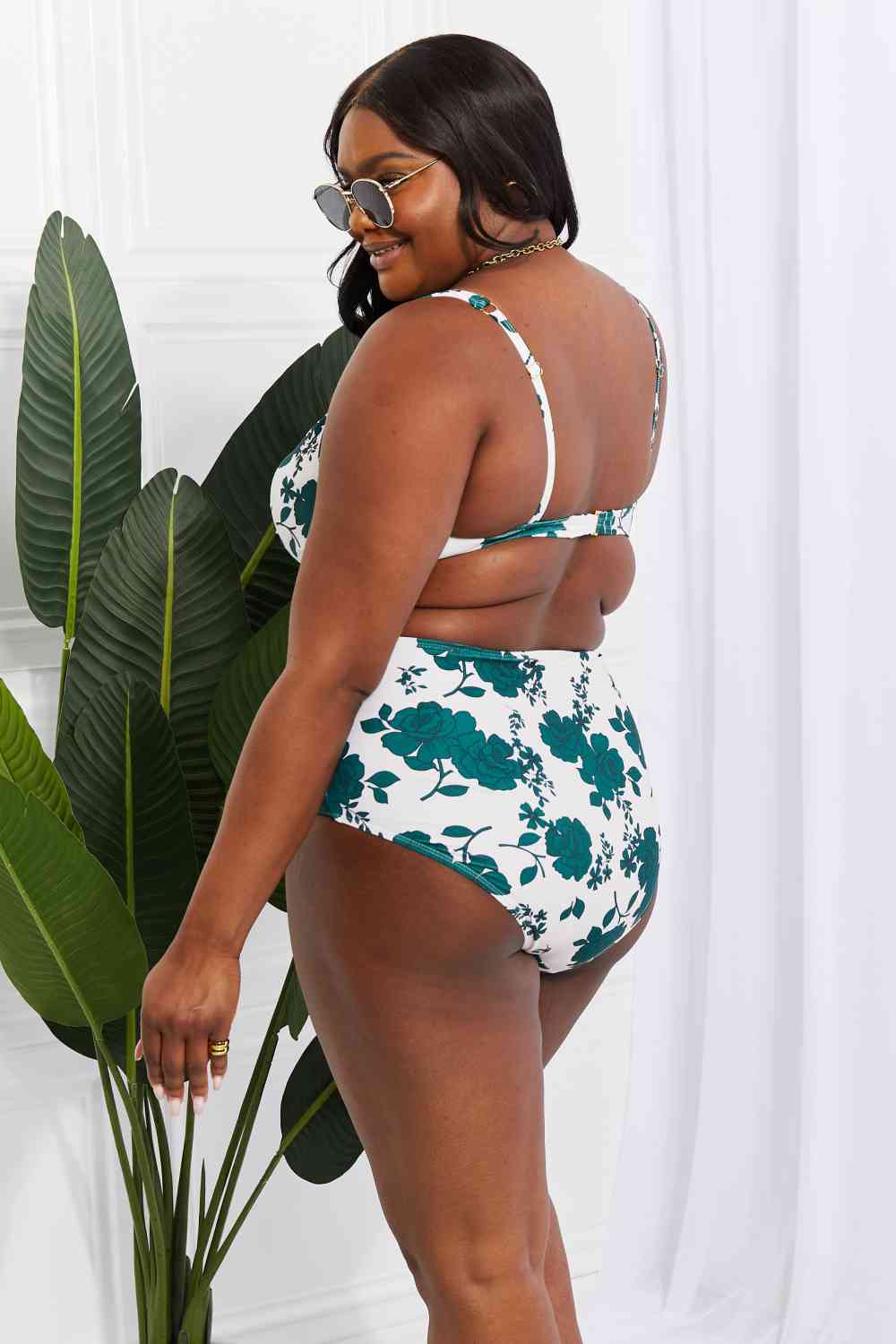 Back view of the plus-size version of the Forest floral high-waisted bikini, featuring the twist-front top and high-rise bottoms. The design ensures comfort and a flattering fit for all body types.