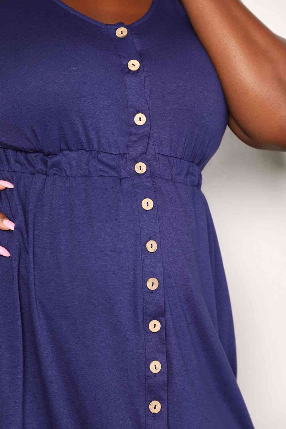 Navy sleeveless dress with a button front, empire waist, and pockets.