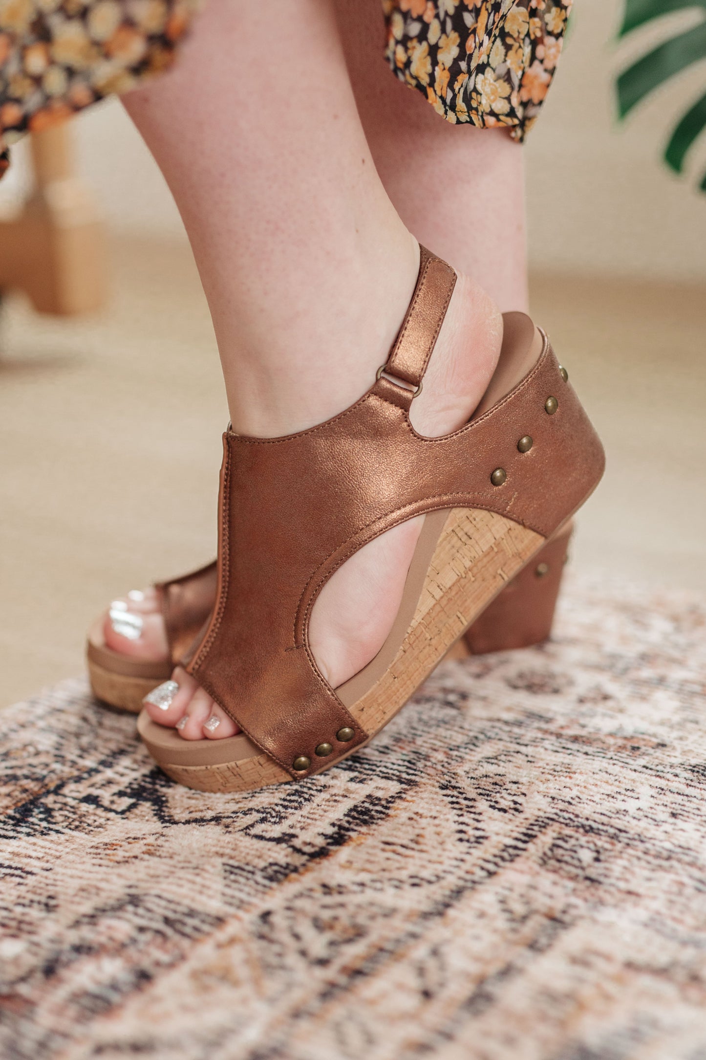 Antique bronze wedge sandals with stud detail, faux leather upper, and memory foam insole for comfort and style.