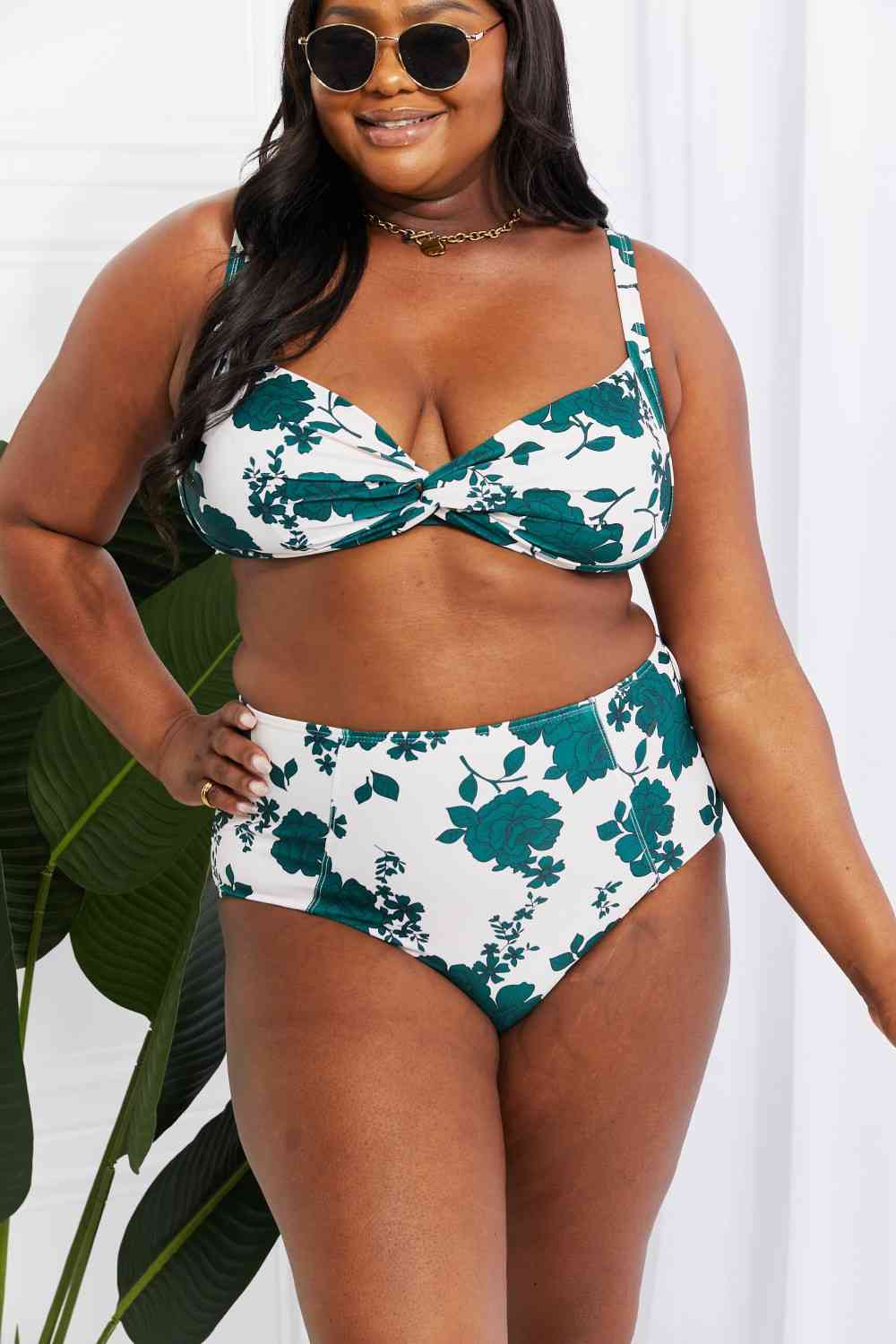 This plus-size high-waisted bikini in Forest features a twist-front top with removable padding and high-rise bottoms. The floral pattern adds fun and charm to your summer wardrobe, designed for comfort and style.