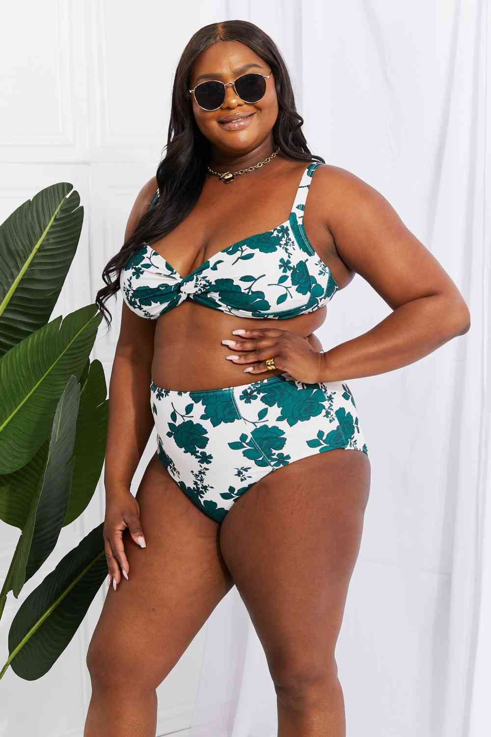 A floral high-waisted bikini in Forest, designed for plus sizes. The twist-front top with removable pads offers a customized fit, while the high-rise bottoms flatter the figure for a confident beach look.